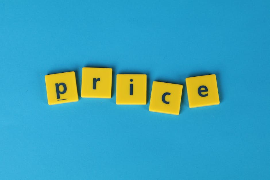A close-up of a printed pricing formula on a clipboard positioned on a beige desk, featuring sections titled 'Materials,' 'Labour,' 'Expertise,' and 'Profit,' with the phrase 'Cost of Product' highlig